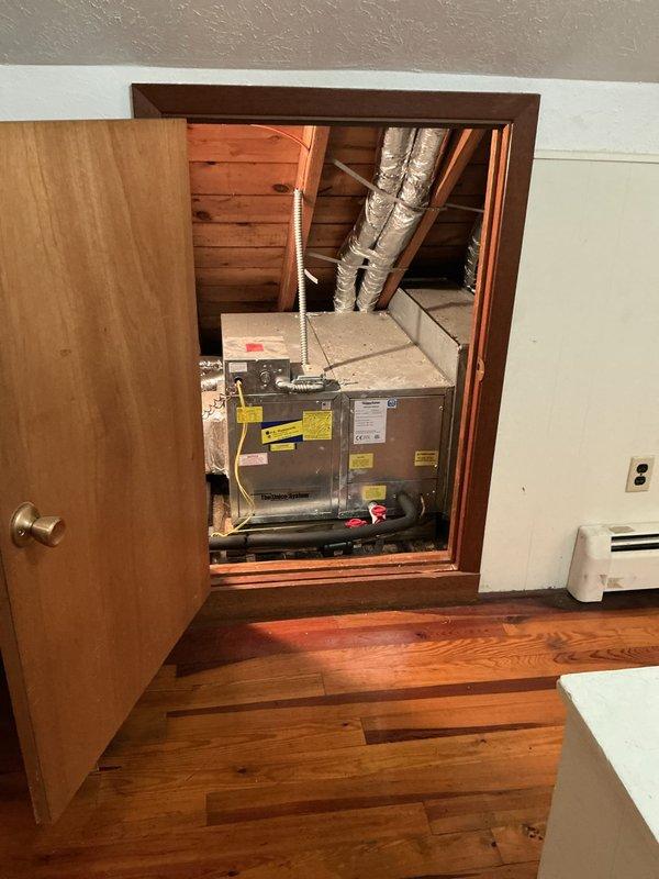 Conducted on-site assessment of existing Unico HVAC system located in attic crawl space to provide replacement options for baseboard heating system currently under repair. Documented equipment configuration including air handler unit, flexible ductwork installation, and existing baseboard heater to develop comprehensive replacement proposal for customer consideration.