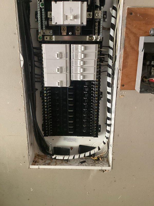 Replaced existing 150-amp main electrical panel with new NEC-compliant service panel, including installation of new interior breaker box with dual circuit breaker arrays and exterior meter base with disconnect switch mounted on wooden backing board. All electrical connections, branch circuits, and main service conductors were properly terminated and secured in accordance with current National Electrical Code requirements.