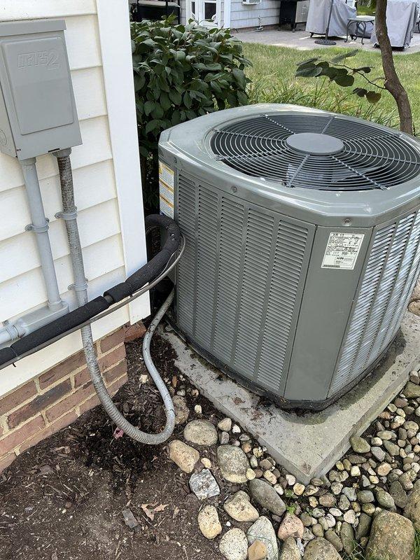 Conducted on-site evaluation of existing residential air conditioning system to provide replacement options. Assessed current outdoor condensing unit located on concrete pad with proper clearances and drainage, documented equipment specifications and installation conditions. Photographed existing system configuration including electrical disconnect, refrigerant line set routing, and equipment accessibility for accurate replacement proposal preparation.