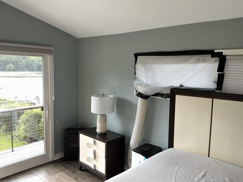 Assessed bedroom with inadequate cooling from central AC system where previous ductwork modifications were unsuccessful. Evaluated electrical panel capacity and verified availability for dedicated mini-split circuit installation. Provided estimate for wall-mounted ductless mini-split system with outdoor condenser unit to serve single room, utilizing sliding glass door access for line set routing.