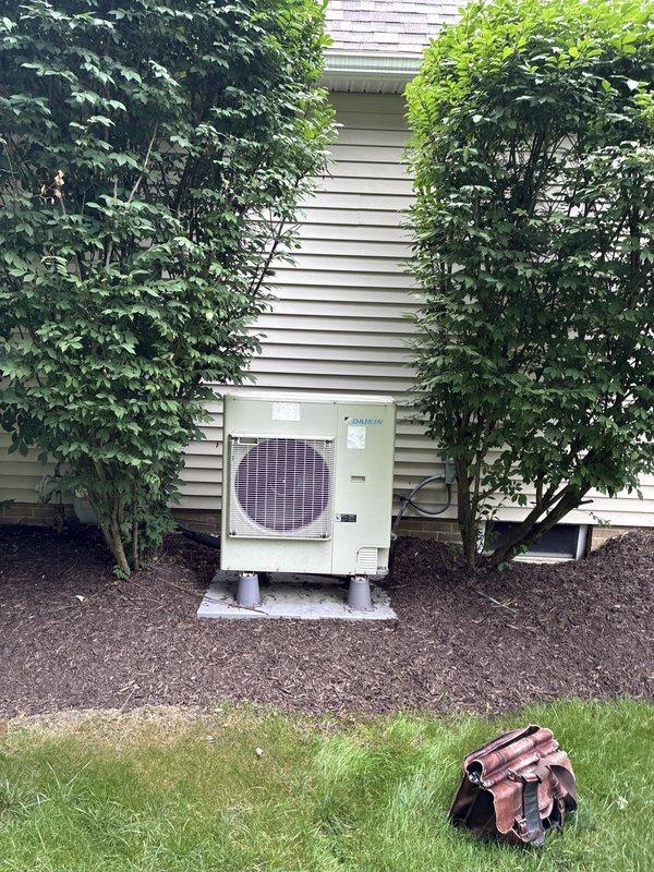 Conducted comprehensive system evaluation for residential HVAC replacement estimate due to inadequate airflow on second floor and partial airflow issues on main level. Assessed existing Daikin heat pump outdoor unit and indoor air handler system installed by previous contractor approximately two years ago. Performed visual inspection of outdoor condenser unit positioned on concrete pad with PVC supports, noting equipment specifications and current operational configuration. Evaluated basement-installed furnace and ductwork assembly, including vertical supply plenum, distribution system, and air handling components. Documented system layout including PVC condensate drainage, venting configuration, and filter accessibility. Analyzed heating and cooling load requirements relative to home square footage and current equipment capacity to determine proper system sizing. Photographed existing equipment installation, ductwork configuration, and mechanical room setup for replacement proposal do