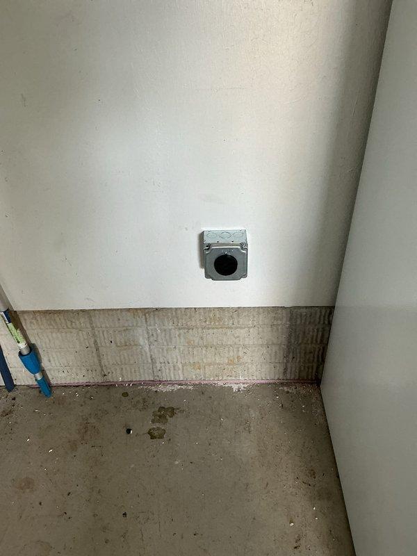 Installed dedicated electrical circuit from main service panel to garage, running new wiring through wall cavities and installing outlet box at designated location. Connected new circuit breaker in panel and verified proper grounding and electrical continuity throughout installation.