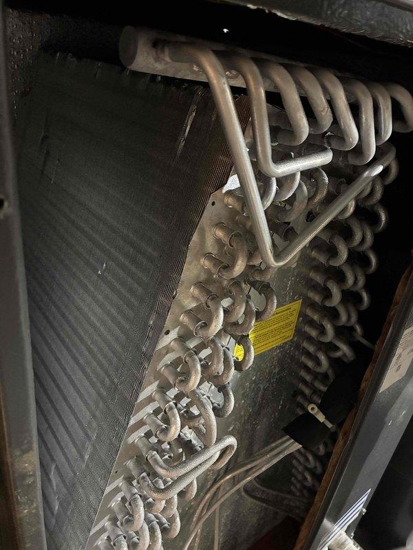 Completed scheduled preventive maintenance on residential air conditioning system. Inspected evaporator coil assembly and serpentine heat exchanger tubing for proper operation, verified refrigerant lines and connections were secure, and confirmed electrical disconnect switch functionality at outdoor unit. All components found to be operating within normal parameters with no immediate service needs identified.