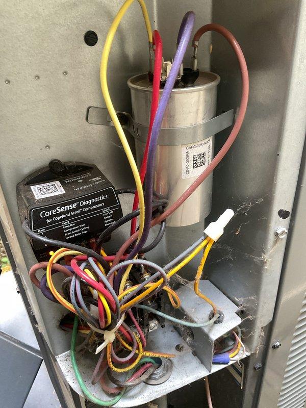 Completed comprehensive cooling maintenance on residential HVAC system located in basement utility area. Performed standard preventative maintenance procedures including inspection of air handler unit, verification of refrigerant line integrity, and examination of electrical components including capacitor and CoreSense Diagnostics monitoring system. All components found to be operating within normal parameters with proper wire connections secured and system functioning as designed.