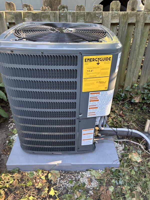 Completed installation of two air conditioning systems at residential property. Installed outdoor condenser units on concrete pads with proper refrigerant line connections and gray insulation, including unit with 13.4 SEER rating. Installed electrical disconnect boxes with Littelfuse FLNR 30A Class RK5 time delay dual element fuses rated at 250 VAC, complete with indicator lights and proper wiring connections.