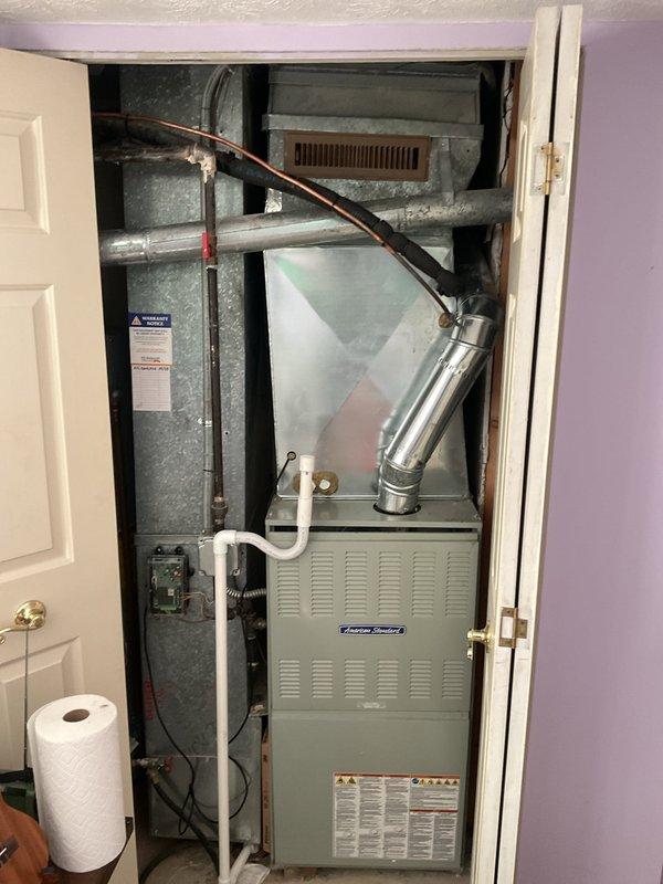 Completed scheduled preventive maintenance on residential American Standard cooling system. Performed comprehensive inspection of indoor air handler unit and associated components, including refrigerant lines, condensate drainage system, and ductwork connections. Evaluated condition of copper refrigerant line insulation and documented deteriorated pipe insulation in mechanical area requiring future attention due to extensive peeling and surface degradation. Verified proper operation of furnace cabinet, air distribution system, and electrical connections. Confirmed condensate drain lines flowing freely through white PVC piping. Inspected exhaust flue system and galvanized ductwork for proper sealing and support. Recorded temperature readings using digital diagnostic equipment to verify system performance parameters within manufacturer specifications. All cooling system components found operational and unit returned to service.