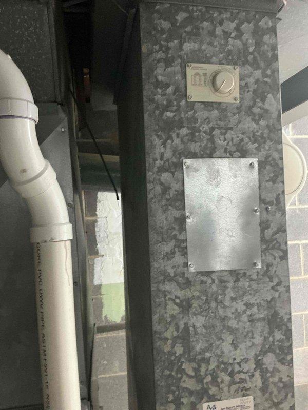 Conducted estimate for replacement of 23-year-old central air conditioning system at single-family residence. Evaluated existing outdoor condensing unit positioned on concrete pad adjacent to brick exterior with vinyl siding, noting age-related wear and end of serviceable life expectancy. Assessed indoor air handler components including ductwork, control panel, and condensate drain line configuration in mechanical space. Documented current system specifications and installation requirements through photographic survey to provide comprehensive replacement recommendations for complete cooling system upgrade.