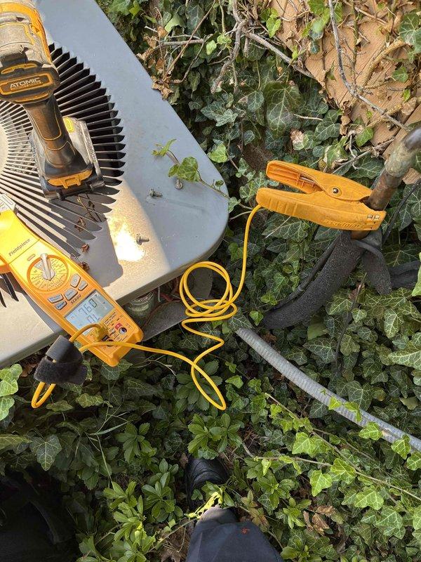 Responded to no cooling complaint on 15-year-old residential air conditioning system where fan was running but unit was not producing cold air. Upon arrival, performed electrical diagnostics on outdoor condenser unit using digital multimeter to test voltage and amperage at compressor. Testing revealed compressor failure, preventing refrigerant compression and heat transfer necessary for cooling operation. Explained findings to homeowner and provided options for repair versus replacement given age of equipment.