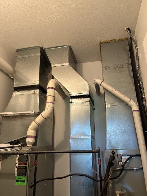 Provided comprehensive full system replacement estimate for large residential property exceeding 3000 square feet with heating and cooling requirements. Presented three-tier equipment options featuring Goodman brand systems: Good tier with up to 13.4 SEER air conditioning and 80% AFUE natural gas furnace, Better tier with up to 14 SEER and 96% AFUE high-efficiency furnace, and Best tier with up to 16 SEER and 96% AFUE for maximum efficiency. Installation location identified as interior closet space with natural gas or propane energy source. Documented existing HVAC infrastructure including sheet metal ductwork, supply and return air plenums, flexible connectors, and proper ventilation components. Photographed current mechanical room configuration showing vertical duct arrangement with galvanized transitions, PVC condensate drainage, and equipment mounting specifications to ensure accurate replacement planning and proper system sizing for optimal performance.