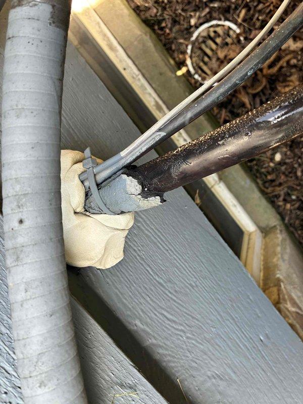 Responded to service call regarding rodent intrusion at outdoor HVAC unit installed in 2020. Upon inspection, discovered damaged insulation around exterior unit with visible deterioration and debris scattered on window sill area. Identified gaps and openings where rodents were accessing equipment and potentially compromising wiring integrity. Inspected copper refrigerant line connections and exterior piping for damage caused by pest activity. Applied expanding foam insulation to seal entry points at pipe penetrations and gaps in building envelope where unit connects to structure. Secured vulnerable areas around lineset and electrical connections to prevent further rodent access and protect system components from wildlife damage.