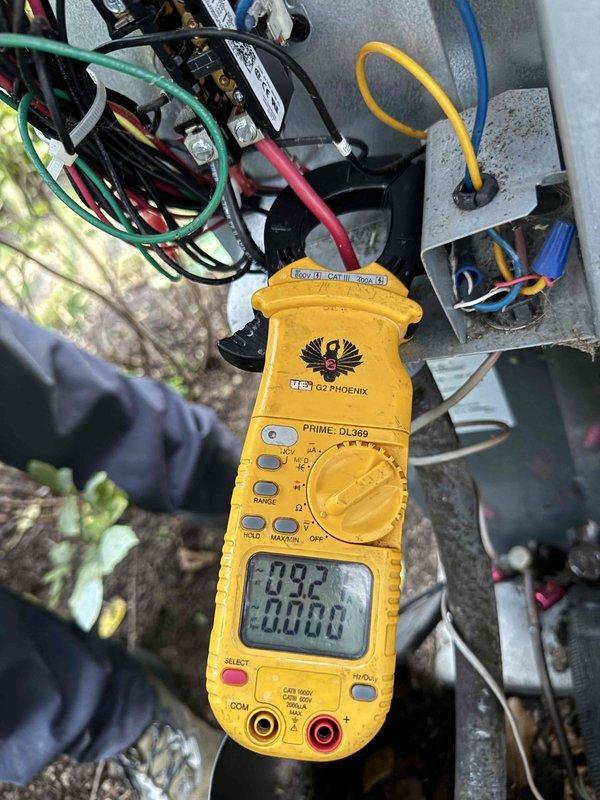 Completed comprehensive cooling system maintenance inspection on residential HVAC unit. Performed electrical diagnostics using digital multimeter to verify capacitor functionality, contactor operation, and proper voltage readings across all electrical components. All measurements indicated normal operating parameters with capacitor showing proper microfarad values and voltage within manufacturer specifications. Inspected condenser coil, heat exchanger, and internal wiring connections for signs of wear, corrosion, or deterioration—all components found in good working condition with secure terminal connections and proper wire routing. System tested and confirmed operational for continued cooling season performance.