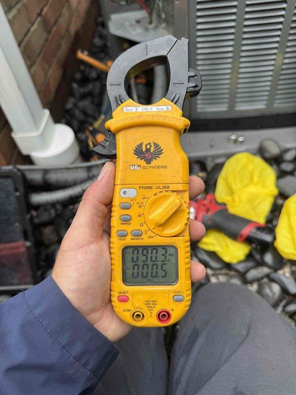 Responded to no cooling complaint on 3-year-old Trane unit following previous chemical cleaning service. Found outdoor condensing unit attempting to start with humming noise but failing to fully engage. Performed electrical diagnostics using clamp meter with unit cover removed, inspecting capacitor, contactor, and associated wiring connections to identify failure point preventing compressor operation.