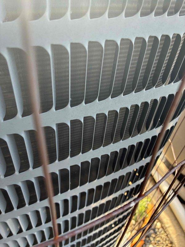 Completed scheduled preventive maintenance inspection on residential cooling system. Inspected condenser coil fins for proper alignment and cleanliness, verified heat exchanger components showing good condition with no visible debris accumulation or deterioration. Examined exterior condensing unit and electrical connections, noting weatherproofing measures in place on utility disconnect box.