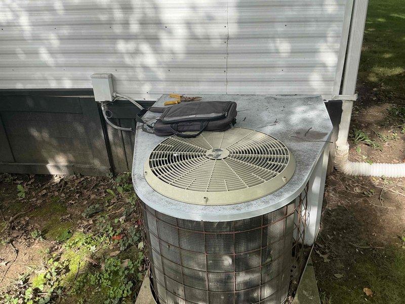 Conducted on-site assessment of existing HVAC system in mobile home for heat pump and air handler replacement estimate. Inspected current equipment located in attic space and exterior condensing unit. Documented existing system configuration, including indoor air handler with furnace components and outdoor heat pump unit. Equipment age could not be determined from available data plates. Evaluated installation accessibility, ductwork connections, electrical service, and mounting locations. Photographed existing equipment and installation areas to support replacement proposal. Provided comprehensive estimate for new heat pump system installation including removal of old equipment, new outdoor condensing unit, indoor air handler, refrigerant lines, electrical connections, thermostat, and startup services.