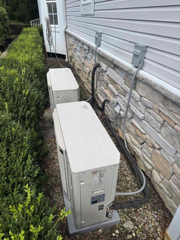 Responded to service call for yellow warning indicator on thermostat controlling one of three residential air conditioning systems installed approximately one year prior. Performed diagnostic evaluation of the affected outdoor condensing unit and corresponding indoor air handler to identify the source of the system alert. Upon inspection of both the exterior equipment positioned on gravel pad and the basement-mounted air handler with associated refrigerant lines and condensate drainage, no active cooling deficiencies or operational failures were detected. All refrigerant lines, electrical connections, and mechanical components appeared properly installed and functioning within normal parameters at time of service visit.