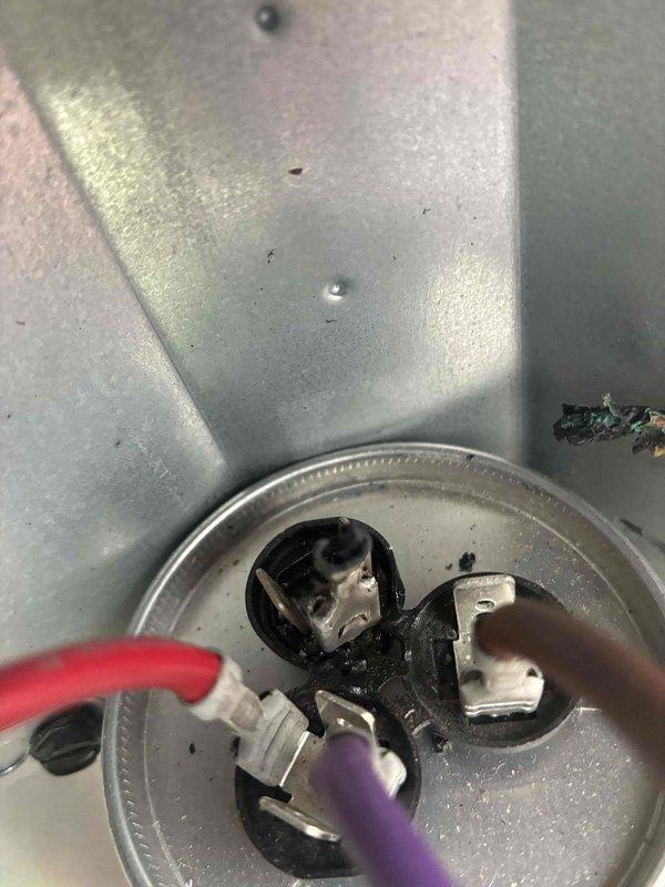 Responded to no-cooling complaint on residential air conditioning unit. Upon inspection, found failed dual run capacitor with visible burn damage and charred wire connections. Removed defective capacitor, cleaned wire terminals, and installed new replacement capacitor with proper electrical connections. Verified system operation and restored cooling functionality.