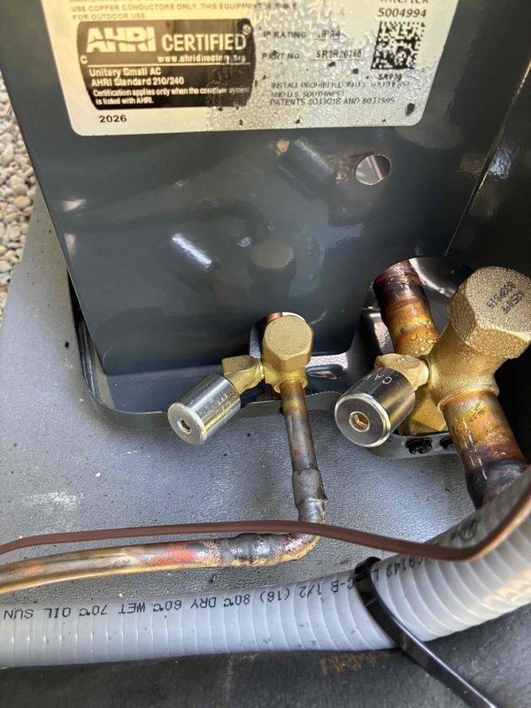 Completed installation of Goodman brand air conditioning system as add-on to existing HVAC setup, coordinated with same-day electrical work. Unit mounted on concrete pad with proper gravel base, all refrigerant lines, electrical conduit, and PVC drain line professionally installed and secured to exterior wall per manufacturer specifications. System tested and verified operational, full balance collected upon completion.