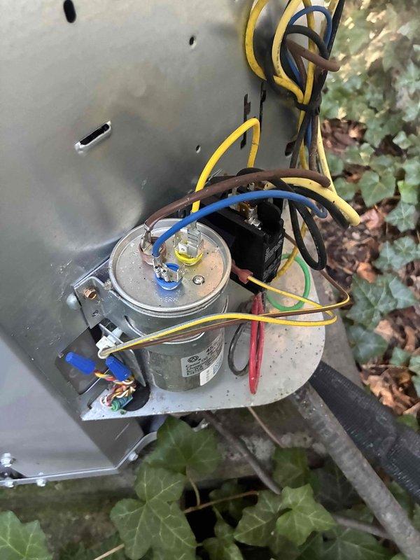 Replaced failed dual run capacitor and installed Zap Pro surge protection device on outdoor condensing unit. System tested and verified operational with proper voltage readings and component function after installation.