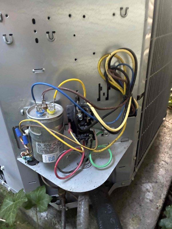 Replaced failed dual run capacitor and installed Zap Pro surge protection device on outdoor condensing unit. System tested and verified operational with proper voltage readings and component function after installation.