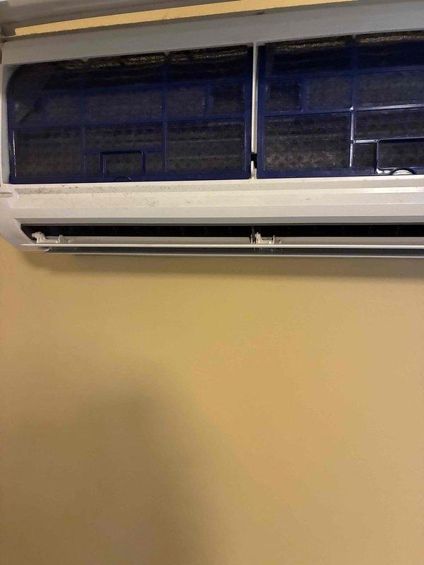 Performed routine maintenance on wall-mounted ductless mini-split air conditioning system. Accessed and inspected internal filter compartment, verified filters were clean and properly seated, and confirmed temperature differential readings with digital thermometer to ensure optimal system performance.