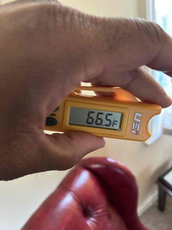 Performed routine maintenance on wall-mounted ductless mini-split air conditioning system. Accessed and inspected internal filter compartment, verified filters were clean and properly seated, and confirmed temperature differential readings with digital thermometer to ensure optimal system performance.