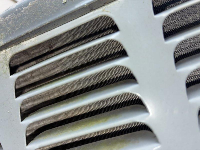 Completed scheduled cooling system maintenance as part of ongoing preventative service plan. Performed comprehensive inspection of evaporator coil assembly, which showed normal dust accumulation between aluminum fins consistent with regular operation. Verified system temperatures using calibrated digital thermometer, recording supply air temperature of 57.3°F, indicating proper cooling performance and adequate refrigerant charge.