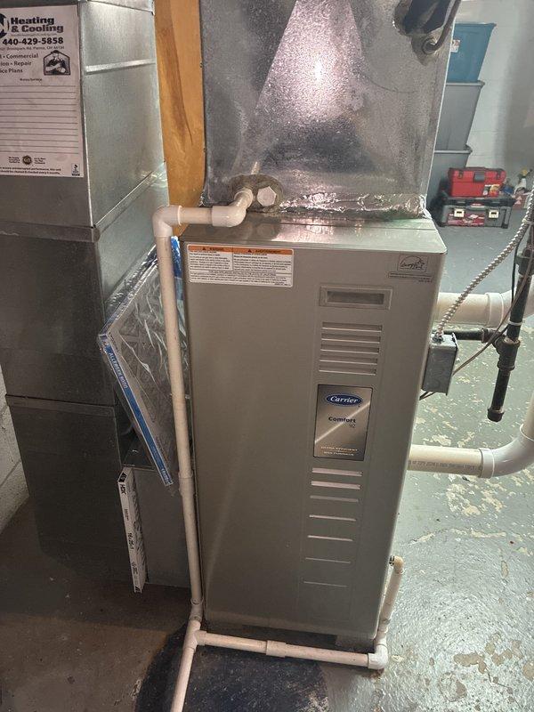 Completed comprehensive cooling system tune-up on Carrier furnace/air handler unit. Performed standard maintenance inspection including motor actuator examination, electrical connections verification, and ductwork assessment. All components found operating within normal parameters with no issues requiring immediate attention.
