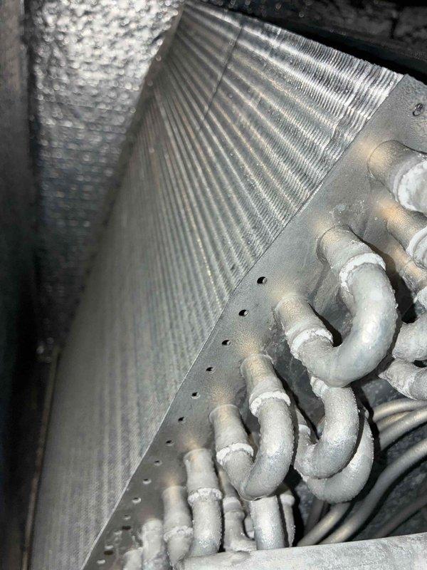 Completed preventive maintenance on two cooling systems. Inspected and documented the condition of both units, including evaporator coils, refrigerant lines, and heat exchanger components. The wall-mounted unit's evaporator coil showed significant dust and debris accumulation requiring attention, while the second system's heat exchanger coil and refrigerant tubing displayed moderate dirt buildup typical of operational wear. Both systems were evaluated for proper operation and component condition as part of routine maintenance protocol.