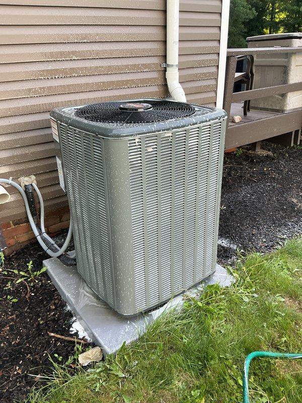 Completed routine cooling maintenance visit on residential HVAC system. Inspected and verified proper operation of outdoor condensing unit, confirmed refrigerant lines and electrical connections were secure, and documented AirScubber air purification system functioning correctly with illuminated LED indicator. All components operating within normal parameters with no issues identified.