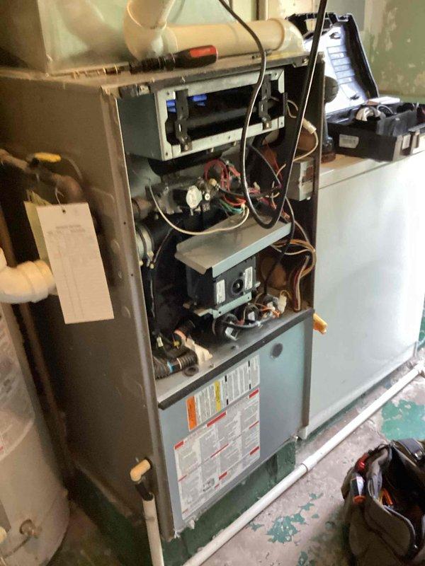Completed heating tune-up on gas furnace system, performing standard maintenance protocols and safety inspections. Utilized combustion analyzer to measure flue gas readings and verify proper burner operation, with measurements indicating acceptable parameters. Inspected internal components including control boards, wiring harnesses, blower assembly, and heat exchanger with access panels removed. Customer advised that furnace replacement may be needed in the near future based on age and condition of equipment.
