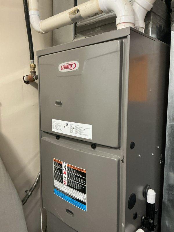 Responded to service call for non-operational air conditioning system with tune-up request. Upon arrival, inspected Lennox HVAC system including furnace unit and air handler assembly. Verified proper installation of 3M Filtrete 16x20x1 air filter in return air section. Examined condensate drain lines and PVC piping for proper drainage and potential blockages. Checked gas line connections at brass shut-off valve and verified secure flexible gas line attachment. Inspected condensate safety switch and overflow protection devices for proper operation. Evaluated ductwork assembly, mounting brackets, and system supports for structural integrity. Performed comprehensive system diagnostics to identify cause of cooling failure and completed preventive maintenance tune-up procedures. Documented equipment condition through photographic records showing filter placement, furnace configuration, and overall system installation.