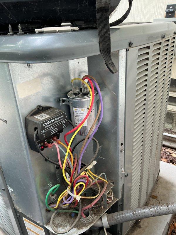 Performed comprehensive maintenance on outdoor HVAC cooling system, including inspection of electrical components, capacitor, and Cor-Sentry device within the condensing unit compartment. Verified system operation through diagnostic testing with calibrated instruments and documented all electrical connections and component conditions for service records.