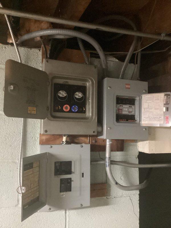 Conducted comprehensive electrical panel assessment for replacement estimate. Evaluated existing multi-panel configuration including main service disconnect with dual metering, secondary distribution panel with circuit breaker arrangement, and lower white load center. Documented current panel conditions, conduit routing through ceiling joists, and copper busbar connections to determine scope of replacement work required.