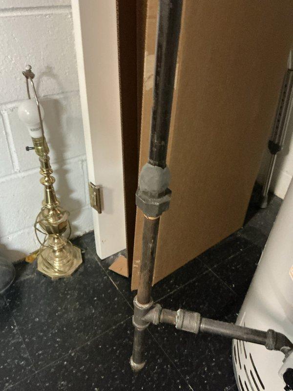Responded to gas leak call at 57-year-old residential property. Located and inspected natural gas piping system in basement utility area. Identified leak at corroded pipe joint connection near water heater. Performed pressure test on gas line to confirm leak location and assess system integrity. Shut off gas supply and repaired compromised fitting, replacing corroded connection with new approved gas-rated components. Conducted post-repair pressure test to verify leak elimination and ensure all connections met code requirements. Restored gas service and documented conditions with photographs for record.