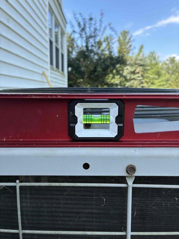 Returned to service location to address outdoor condensing unit that was not level. Used precision leveling tools to assess and correct unit positioning on concrete pad, ensuring proper drainage and optimal compressor operation. Replaced failed dual-run capacitor to restore system functionality and prevent compressor damage.