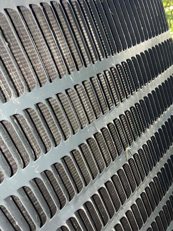 Performed comprehensive coil cleaning on outdoor condensing unit that exhibited heavy accumulation of dirt, debris, and organic matter on exterior surfaces and internal components. Thoroughly cleaned condenser coils, removing built-up contamination from fins and restoring proper airflow capacity to ensure optimal heat transfer efficiency and system performance.