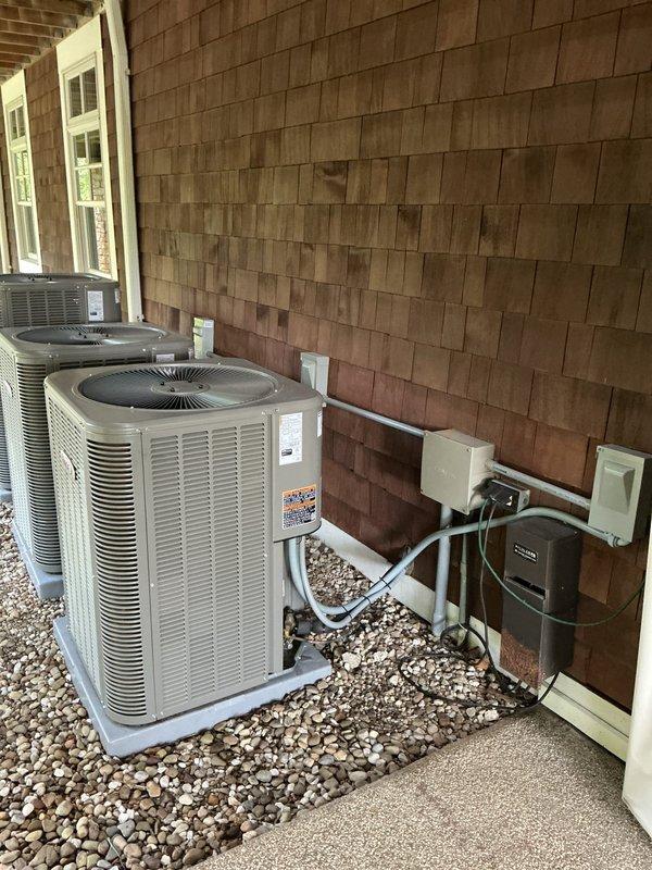 Completed comprehensive cooling maintenance on three HVAC systems as part of recurring preventive maintenance program. Serviced indoor furnace/air handler unit located in basement mechanical room, including inspection of ductwork, venting system, and electrical connections. Performed maintenance on two outdoor condenser units positioned on gravel pad beneath covered porch area, verifying proper operation of compressors, fan motors, and refrigerant levels. All three systems inspected, cleaned, and confirmed operational with no issues identified requiring repair.