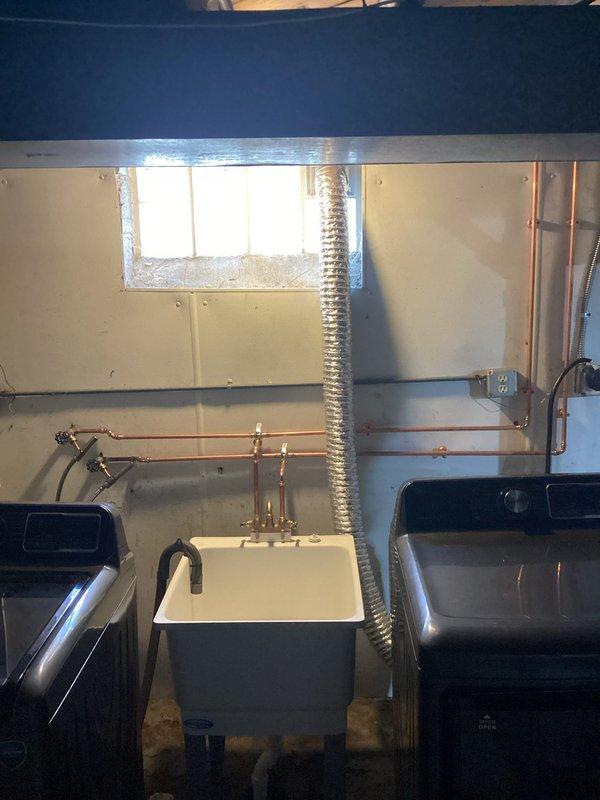 Installed new laundry tub with faucet assembly and connected water supply lines in basement utility area. Completed all necessary plumbing connections to ensure proper drainage and water flow to the fixture.