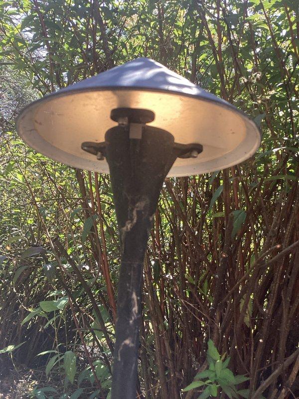 Retrenched low voltage wiring to outdoor landscape light fixture and installed new transformer. Replaced damaged or deteriorated underground cable run and restored proper power supply to pole-mounted light along landscaped walkway area.