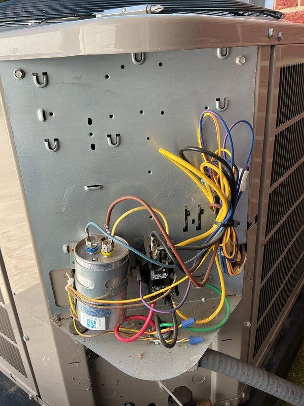 Responded to service call for continuous water discharge from Bryant AC unit. Upon inspection, found condensate drainage issue causing water stream from unit. Inspected interior components including capacitor, contactor, and electrical connections which appeared in serviceable condition. Addressed drainage concern to restore proper condensate removal and prevent water accumulation around unit exterior.