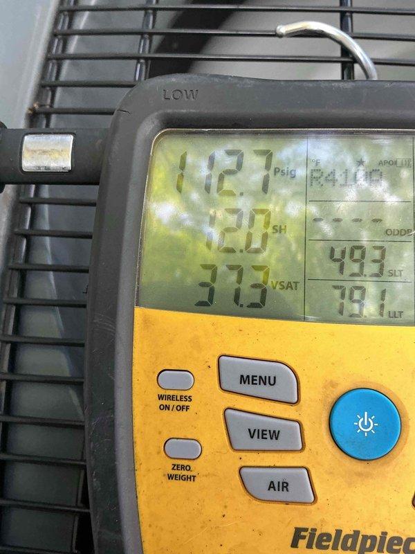 Completed preventive maintenance on HVAC cooling system. Performed system diagnostics using digital manifold gauge set, recording operational pressures at 112.7 PSIG on low side with superheat reading of 52.0°F and subcooling index of 493. Inspected electrical disconnect and fuse panel, confirming proper fuse installation and operation. System operating within normal parameters with no deficiencies noted.