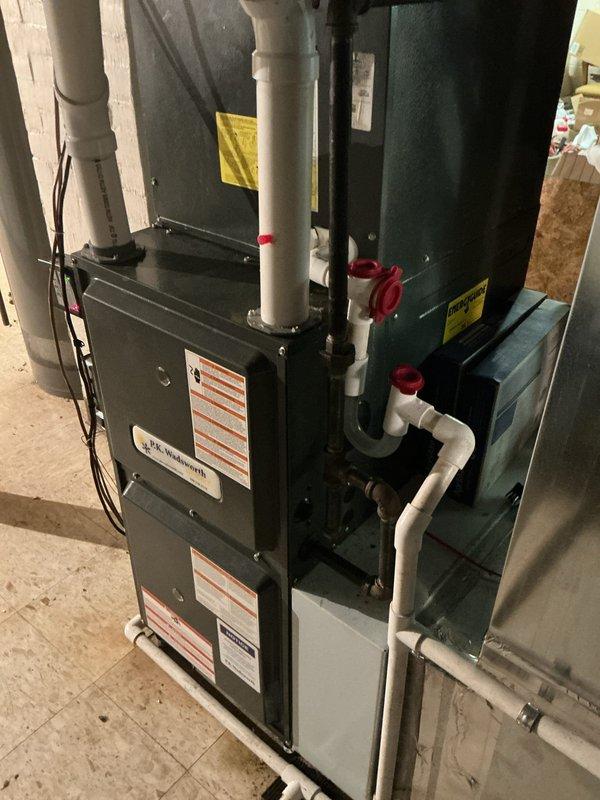 Completed scheduled preventive maintenance on residential cooling system. Performed comprehensive inspection of air handler unit, verified Aprilaire thermostat operation displaying proper temperature reading, checked all electrical connections and control wiring, inspected condensate drainage system and PVC piping with proper valve function, and confirmed all system components operating within normal parameters.