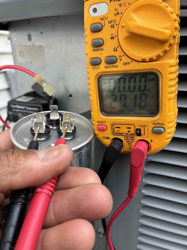 # HVAC Cooling System Maintenance

Completed routine preventive maintenance on residential cooling system as part of ongoing service plan. Performed comprehensive electrical diagnostics on system components, including capacitor testing using digital multimeter to verify proper voltage and capacitance readings. Measured electrical values at capacitor terminals, confirming operational parameters were within manufacturer specifications at 218V and 20.00 microfarads. Inspected all electrical connections, wiring, and control components for signs of wear or deterioration. All tested components functioning properly with no deficiencies noted. System operational and ready for continued service.