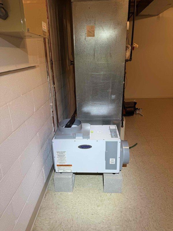 Completed installation of dehumidifier system with three electrical disconnects for whole-home humidity control. Integrated new equipment with existing Carrier air handler in basement and Amana outdoor condenser unit, ensuring proper electrical connections and system compatibility for enhanced indoor air quality management.