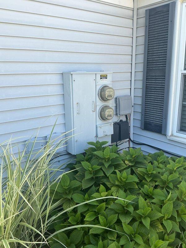 Conducted comprehensive site assessment for electric vehicle charging station installation at residential property. Evaluated existing electrical service capacity at exterior meter location and identified optimal interior garage routing path for dedicated EV charger circuit, documenting current electrical infrastructure and proposed installation pathway through detailed photographic documentation.