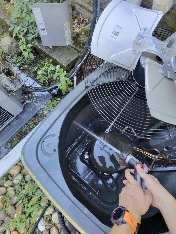 # HVAC Cooling Maintenance Completed

Performed comprehensive preventive maintenance on outdoor condensing unit as part of scheduled cooling system service. Upon arrival, opened and inspected condenser unit, revealing significant accumulation of organic debris including leaves, twigs, and decomposed plant material in the base compartment. Removed all debris from unit interior to restore proper airflow and prevent potential drainage issues or component damage.

Conducted thorough electrical diagnostics using testing equipment to verify compressor operation, fan motor function, and overall system performance. Inspected internal components including compressor, fan assembly, electrical wiring, and refrigerant lines for signs of wear or damage. All electrical connections found secure with no visible deterioration. Copper refrigerant tubing showed no signs of corrosion or leaks.

Verified proper fan operation and motor function on both main condenser fan and internal circulation components.