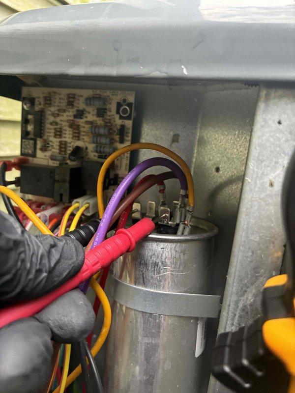 Completed routine HVAC cooling system maintenance including comprehensive inspection of electrical control panel, contactors, and wiring connections. Performed diagnostic testing of the system capacitor using multimeter to verify proper electrical function and capacity readings, with all components found to be operating within normal parameters.