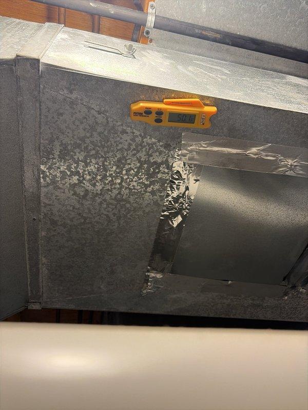Completed preventive maintenance service on two cooling systems. During inspection, discovered severe frost accumulation and ice buildup on supply ductwork in attic space, with temperature reading of -3.0°F indicating excessive cooling and potential refrigerant or airflow issues. Noted damaged duct insulation with torn foil facing exposing fibrous material, which may contribute to condensation problems and reduced system efficiency. Inspected furnace unit and associated HVAC equipment in mechanical room, verified proper installation of PVC venting and metal ductwork connections. Both systems evaluated for seasonal cooling performance and operational safety.