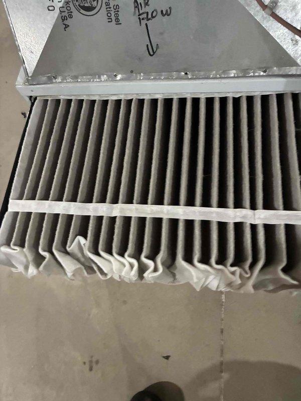 Completed scheduled preventive maintenance on residential cooling system as part of ongoing service plan. Inspected outdoor condenser unit and found significant accumulation of leaves, twigs, and debris around base and corner sections; cleared all organic material from equipment perimeter to ensure proper airflow and prevent potential drainage issues. Examined and serviced pleated air filter in return air housing, verified proper installation with airflow direction indicator, and confirmed secure mounting within metal framework to maintain optimal system efficiency and indoor air quality.