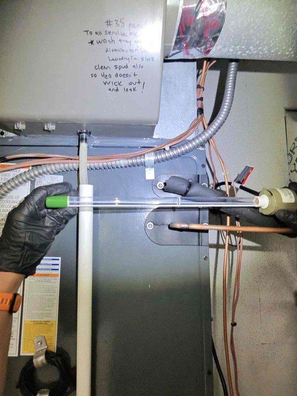 Replaced two UV bulbs in the HVAC system's air handler unit to restore proper air purification functionality. Verified system operation and confirmed thermostat was maintaining proper temperature setpoint at 68 degrees. Documentation photos were taken of the equipment and surrounding areas per customer request.